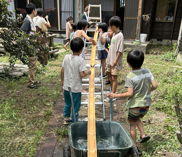 【こども食堂 笑虹然～ecoZEN】流しそうめんをする様子